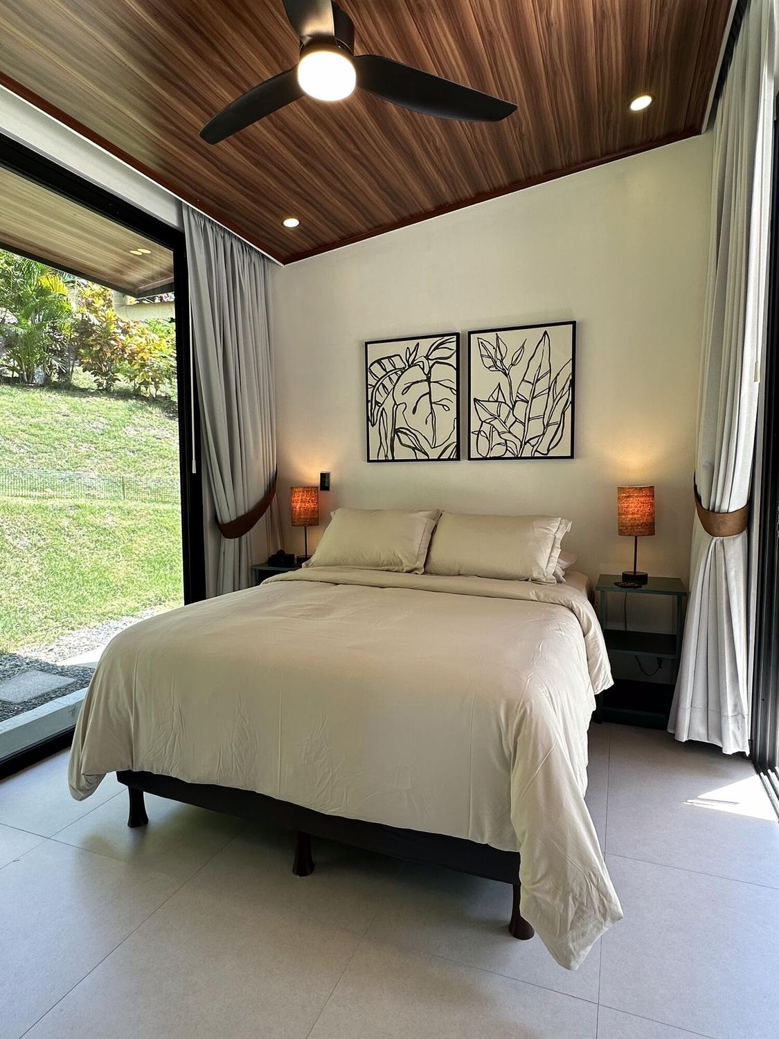 Bedroom with queen bed and garden views