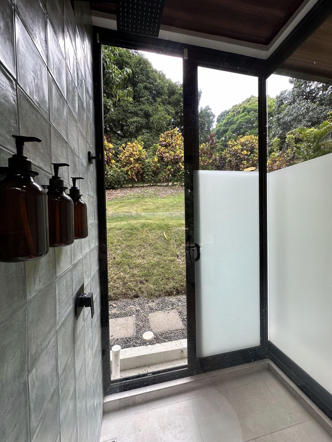 Walk-in shower opening to a private garden